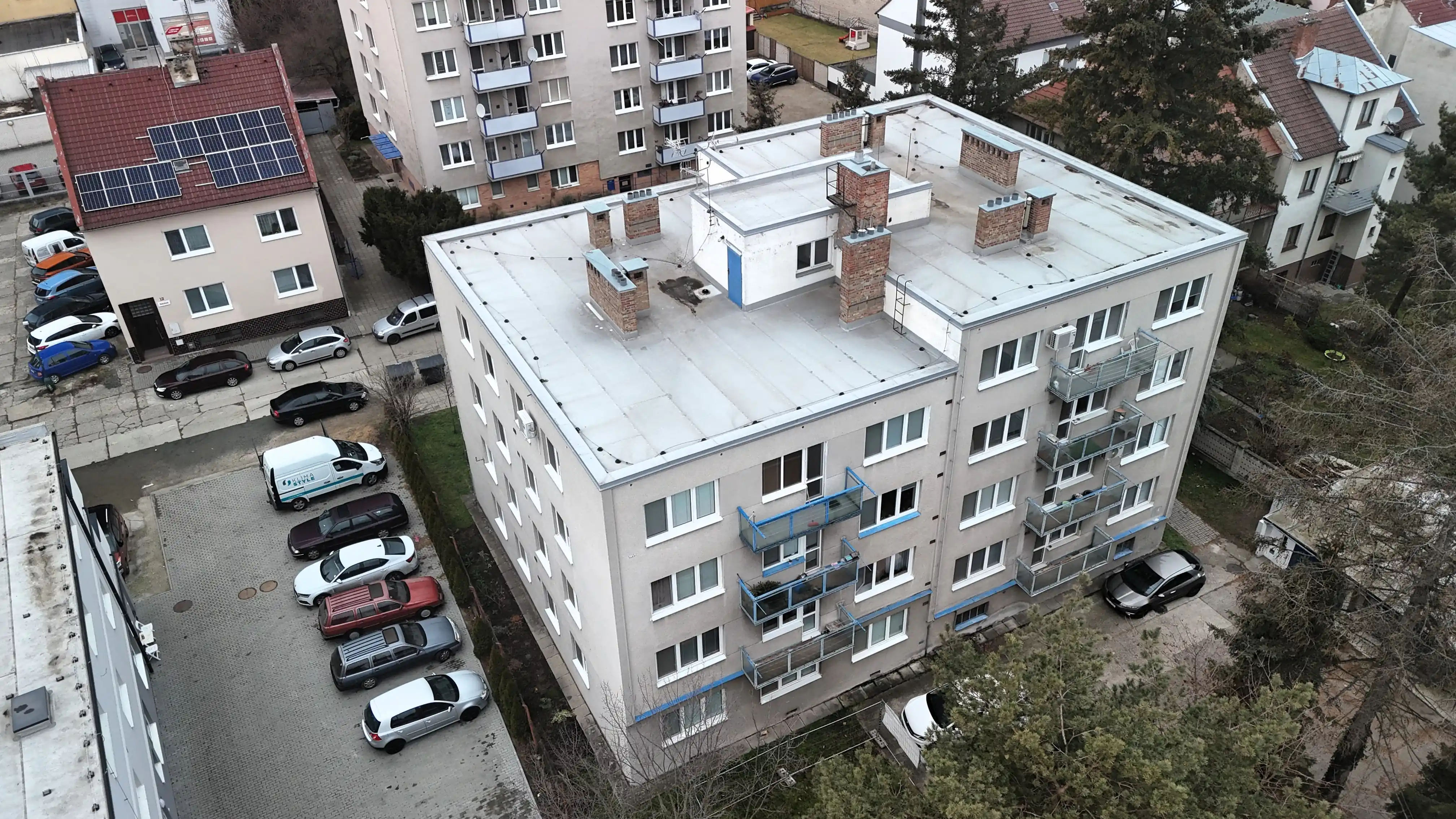 šikmý letecký pohled na dům a balkony před revitalizací.